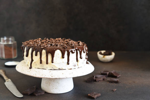 istock Chocolate truffle cake with cream cheese on a dark background. 1272250531