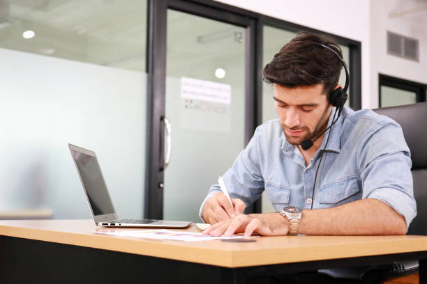 istock Caucasian businessman IT operator answering online phone call from customer as 24/7 customer service 1272251817