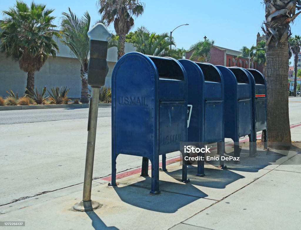 Four Mailboxes on the Sidewalk Four mailboxes next to each other on the sidewalk in Santa Monica, CA. Mailbox Stock Photo