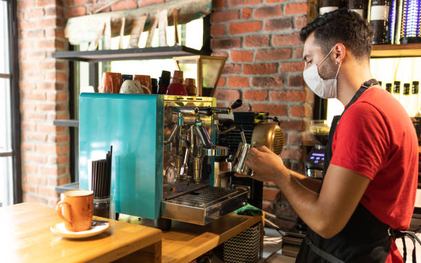 istock Male barista making cappuccino with protective face mask 1272256853