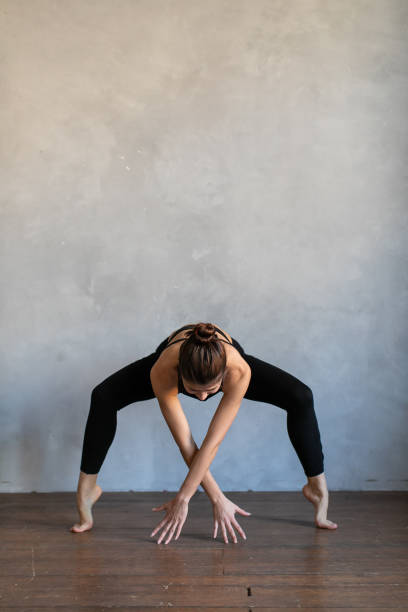 istock .Girl balancing, practice stretch exercise at yoga class. 1272256932