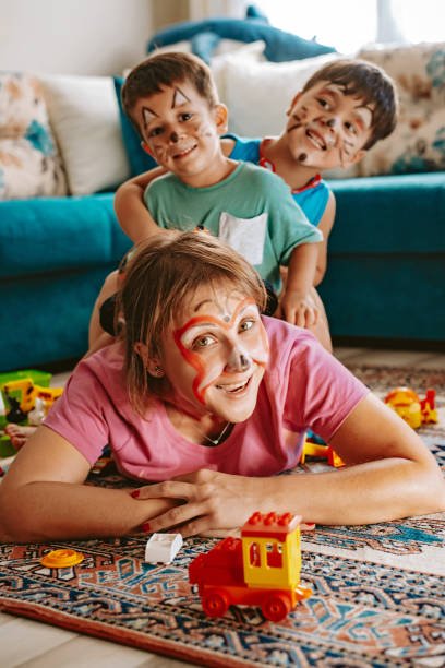 istock Kids playing with mother at home 1272256989