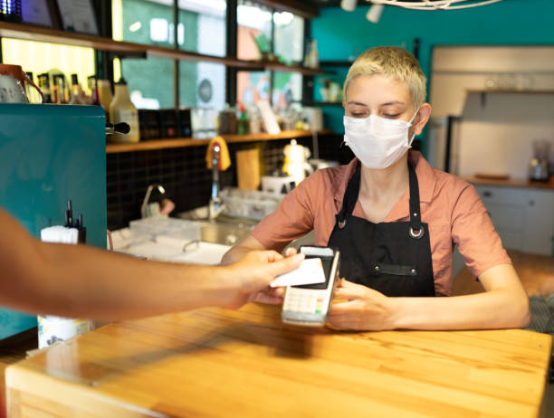 istock Men paying contactless payment with debit card 1272256991