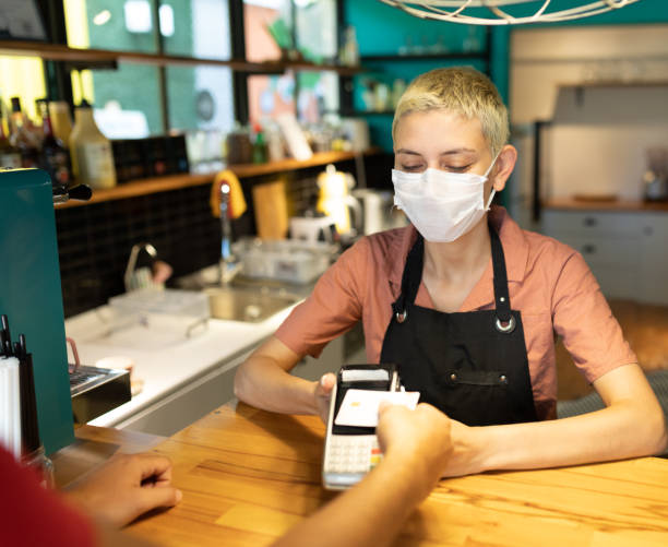 istock Men paying contactless payment with debit card 1272257090