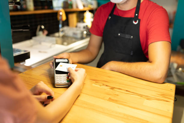 istock Women paying contactless payment with debit card 1272257718