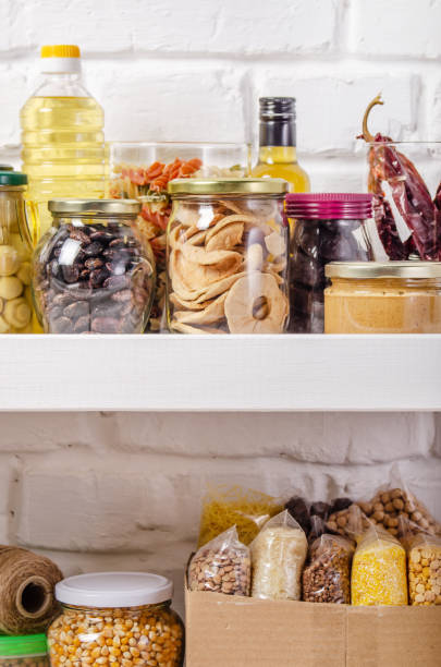 istock Set of non-perishable foods on pantry shelf on brick wall background 1272257916