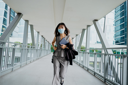 Young Asian Businesswoman Wearing Face Mask And Rushing To Work Stock ...