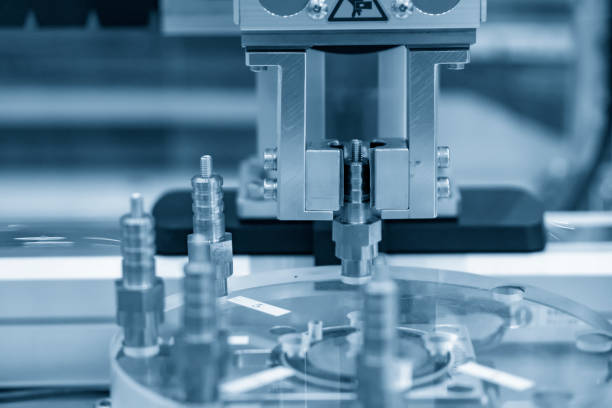 istock The automatic robotic arm gripping the spark plug part. 1272262989