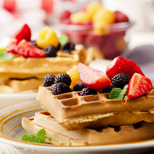 istock CLoseup view at belgian waffles served with strawberries and blackberries on kitchen table 1272262991