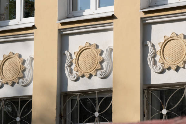 istock Building facade decoration with sun symbolsamong windows 1272267134