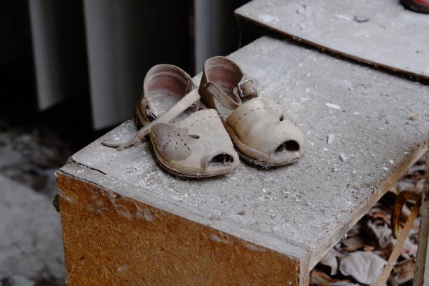 Small children's sandals in an abandoned kindergarten in Pripyat. Old children's shoes. Small children's sandals in an abandoned kindergarten in Pripyat. Old children's shoes. pripyat city photos stock pictures, royalty-free photos & images