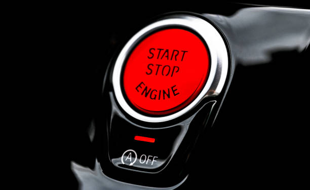 istock Car dashboard with focus on red engine start stop button. Modern car interior details. start/stop button. Car inside. Ignition remote starter 1272270693