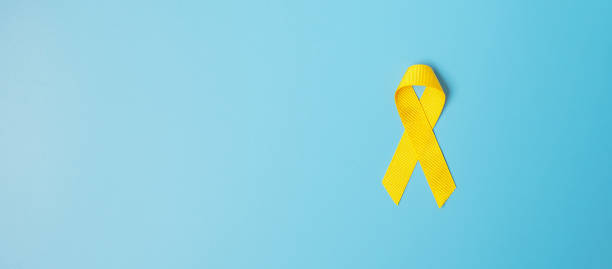 Childhood Cancer, Sarcoma, bone, bladder and Suicide prevention Awareness month, Gold Yellow Ribbon for supporting people living and illness. children Healthcare and World cancer day concept Childhood Cancer, Sarcoma, bone, bladder and Suicide prevention Awareness month, Gold Yellow Ribbon for supporting people living and illness. children Healthcare and World cancer day concept suicide photos stock pictures, royalty-free photos & images