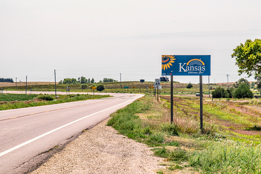 Chester, United States - August 15, 2020:  The sign along the highway at the border of Kansas and Nebraska welcoming travelers to the state of Kansas.