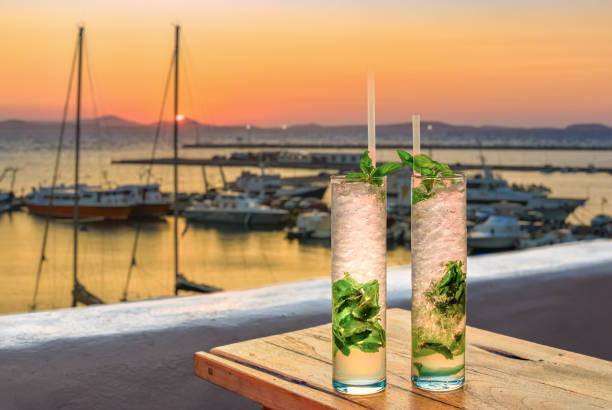 two drinks in front of a mediterranean harbor