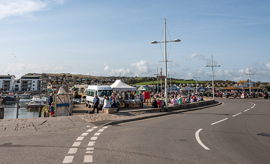 West Bay, UK. Saturday 12 September 2020. People look at the harbour and the road through West Bay in Dorset