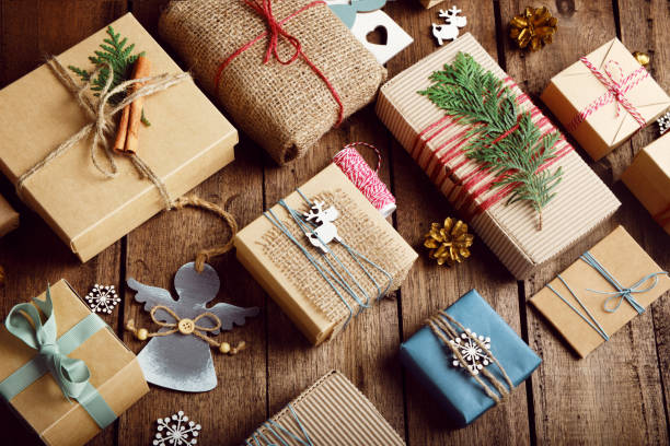 Christmas gifts on a wooden table. Ecological packaging. Zero waste holidays. Christmas gifts on a wooden table. Ecological packaging. Zero waste holidays. burlap photos stock pictures, royalty-free photos & images