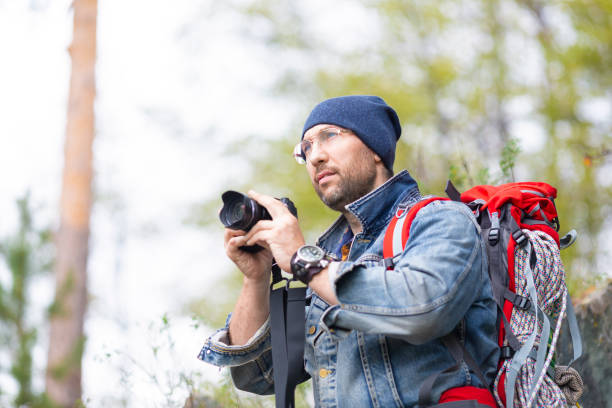 istock Middle aged bearded male hiker with camera. 1272280805