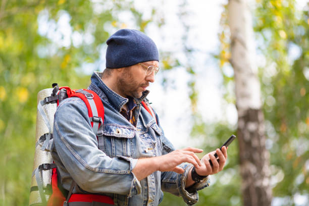 istock Middle aged hiker looking at his mobile phone. 1272280816