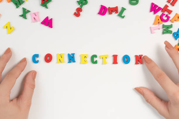 istock Female hands lay out the word connection from colored letters 1272282328