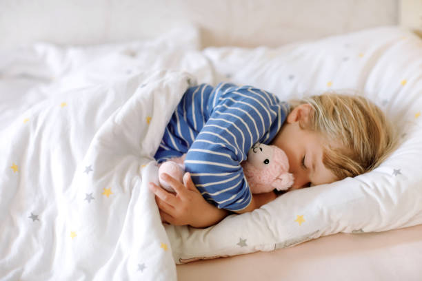 Cute little toddler girl sleeping in bed with favourite soft plush toy lama. Adorable baby child dreaming, healthy sleep of children by day. Cute little toddler girl sleeping in bed with favourite soft plush toy lama. Adorable baby child dreaming, healthy sleep of children by day deep pick stock pictures, royalty-free photos & images