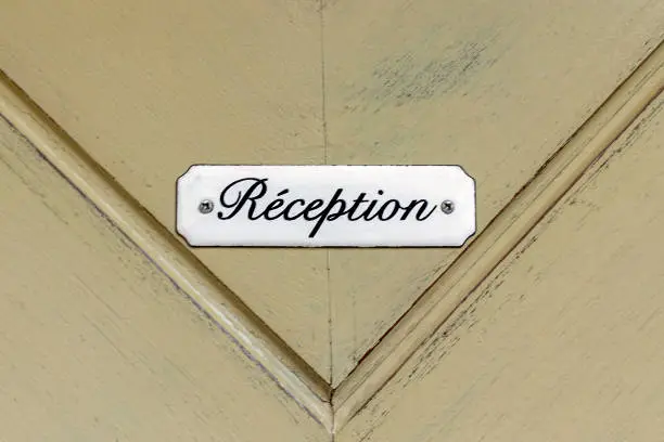 Photo of Reception sign on vintage door.