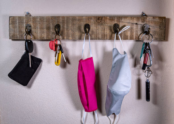 Key rack with keys and face masks stock photo