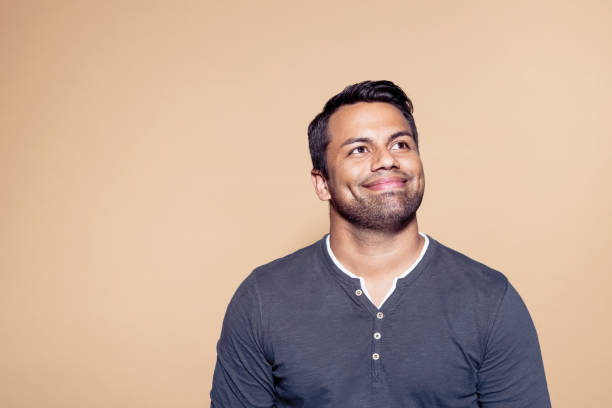 istock Smiling businessman over brown colored background 1272287130