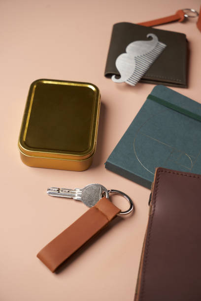 Men's backpack and accessories on pastel background Men's backpack and accessories on pastel background. Flat lay style. Trendy Hipster backpack with textbook, keys, leather wallet and other phone wallet keys stock pictures, royalty-free photos & images
