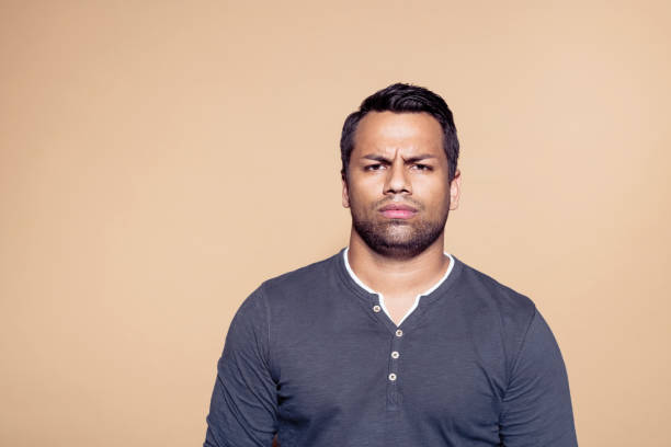 istock Confused businessman over brown background 1272287529