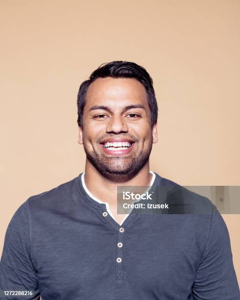 Cheerful Entrepreneur Against Brown Background Stock Photo - Download Image Now - Happiness, Studio Shot, 25-29 Years