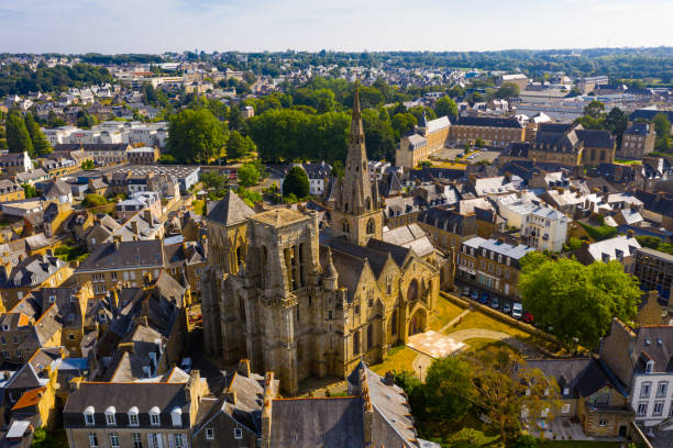 Aerial view of historic centre of Guingamp with Basilica, France Aerial view of historic centre of Guingamp overlooking ancient Basilica of Notre Dame de Bon Secours, Brittany, France guingamp brittany stock pictures, royalty-free photos & images