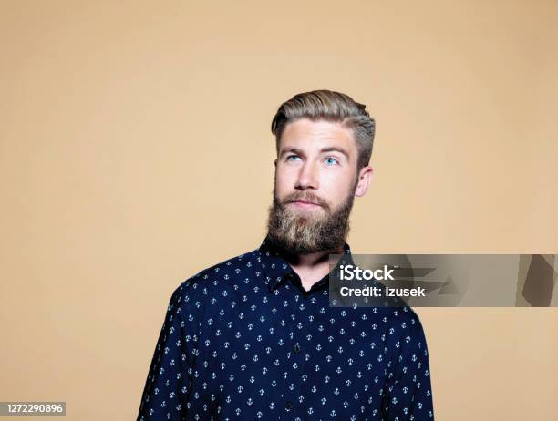 Thoughtful Businessman Over Brown Background Stock Photo - Download Image Now - Brown Background, One Person, People