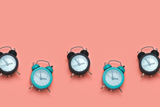 istock black and blue clock on a pastel orange background, time and deadline concept copy space 1272291791