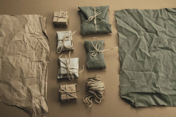 istock textile and kraft paper gift boxes on a brown background 1272291827