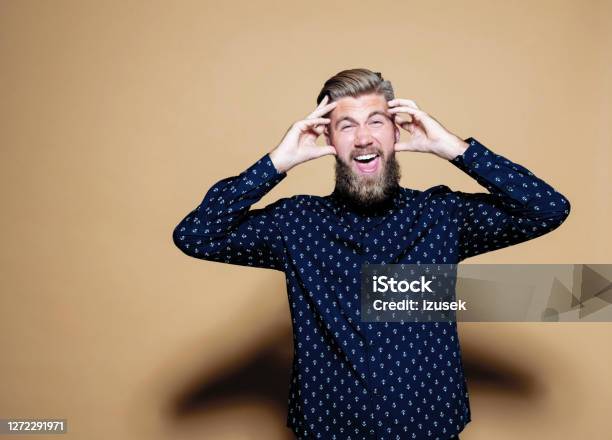 Frustrated Businessman Against Brown Background Stock Photo - Download Image Now - Entrepreneur, Photography, Studio Shot