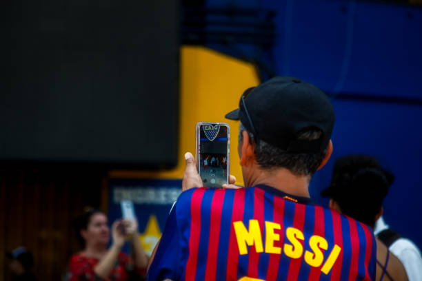 touriste avec lionel messi chemise prend une photo de sa femme à l’entrée du stade boca juniors club - messy photos et images de collection