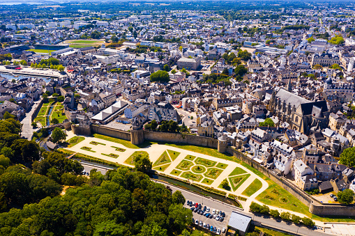 Drone view of Vannes overlooking fortified city walls and lawns with floral design, Brittany, France