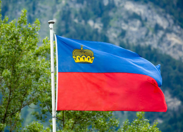 istock Liechtenstein flag waving on mountain background 1272293522