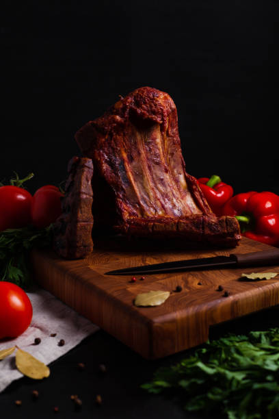 istock Smoked BBQ ribs on black background 1272293575