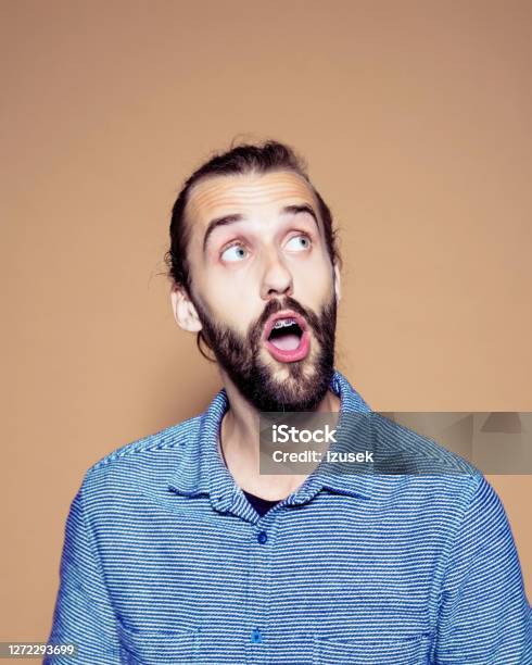 Shocked Businessman Over Brown Background Stock Photo - Download Image Now - 25-29 Years, Adult, Adults Only