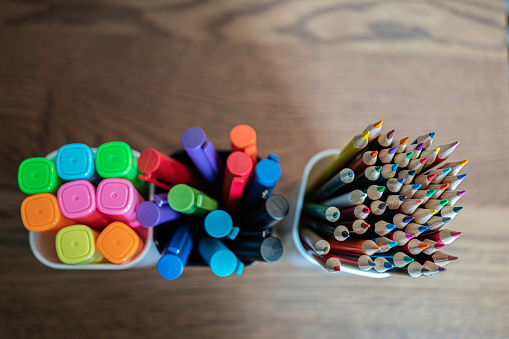 Collection of colored Pencils, pens and highligters in cups