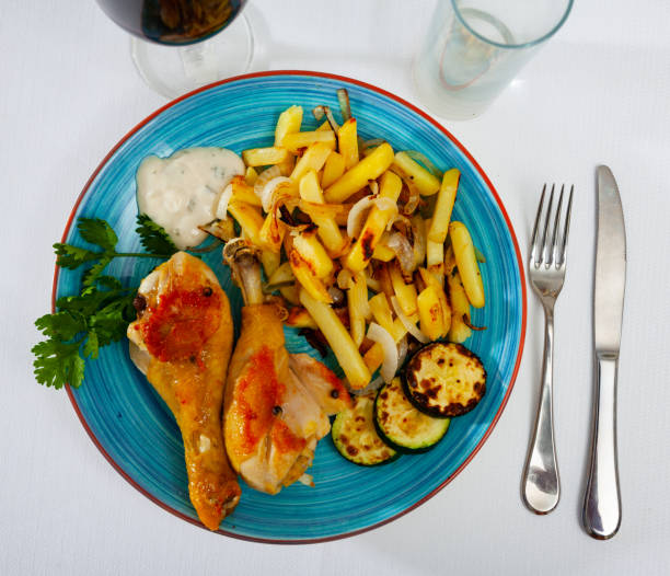 istock Chicken legs with fried potato and zucchini 1272295944