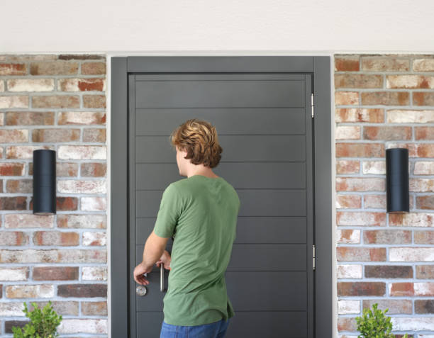 istock man opening the door .Inviting the guests 1272296748