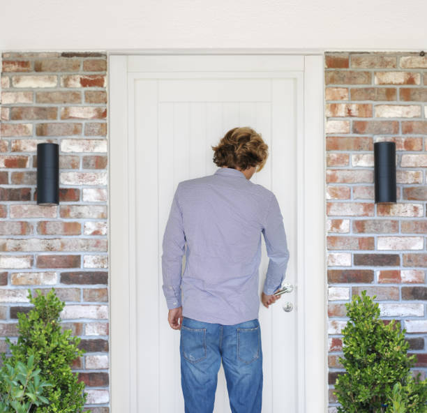istock man opening the door .Inviting the guests 1272296749