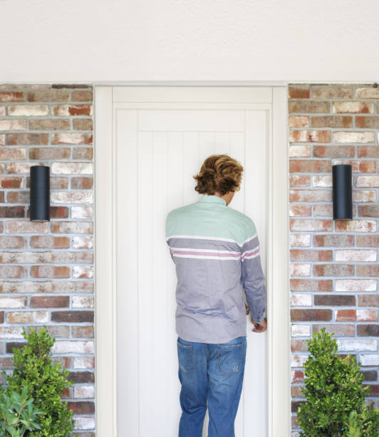 istock man opening the door .Inviting the guests 1272296751