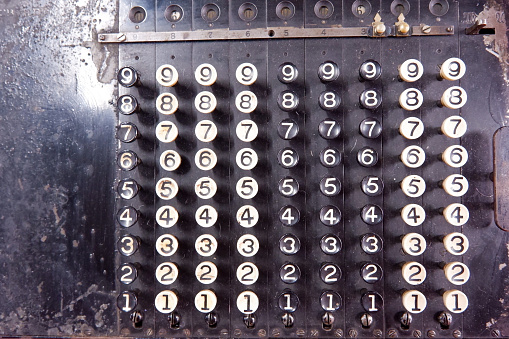 Close-up of keypad of an old electric calculating machine.