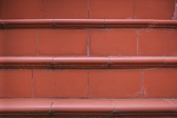 Red brown tiles steps cottage stairs shooted in front view with selective focus with day light