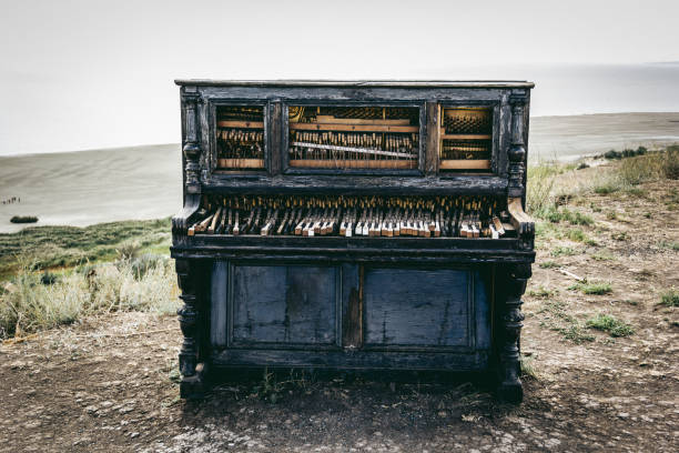 Old broken piano. Piano on beach stock photo