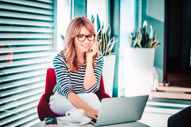 istock Happy middle aged woman working from home 1272303203